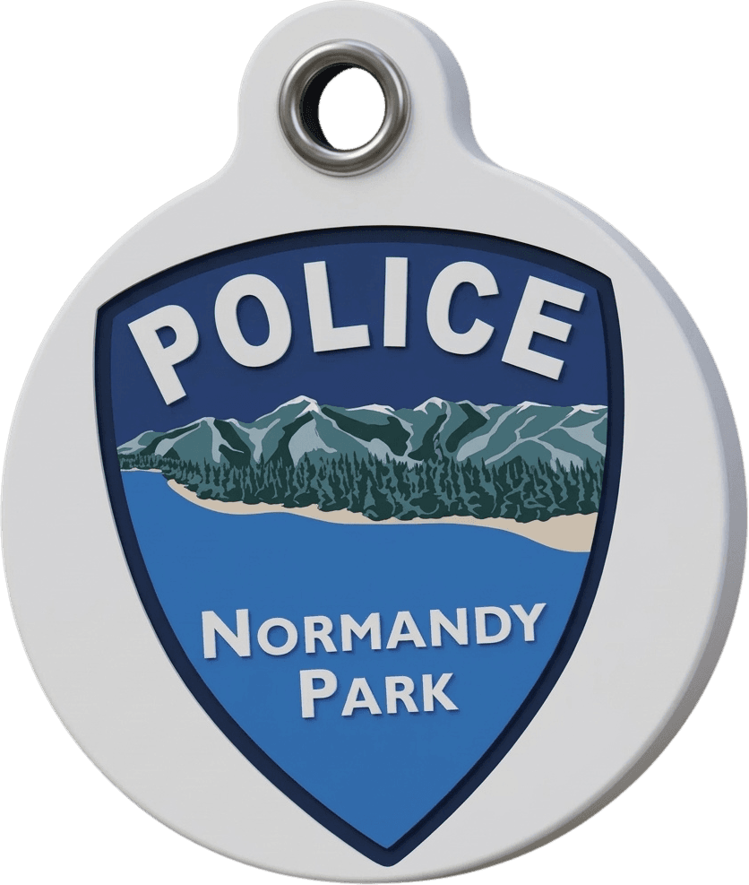 A Paws on Patrol dog tag: round and white, with the Normandy Park Police shield.