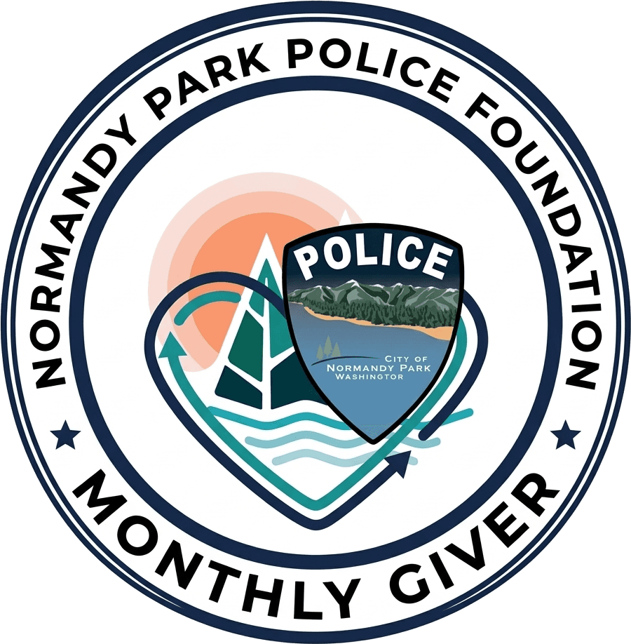 The Normandy Park Police Foundation's Monthly Giver badge: a heart around the Normandy Park police shield, with a tree, the sun and the water.