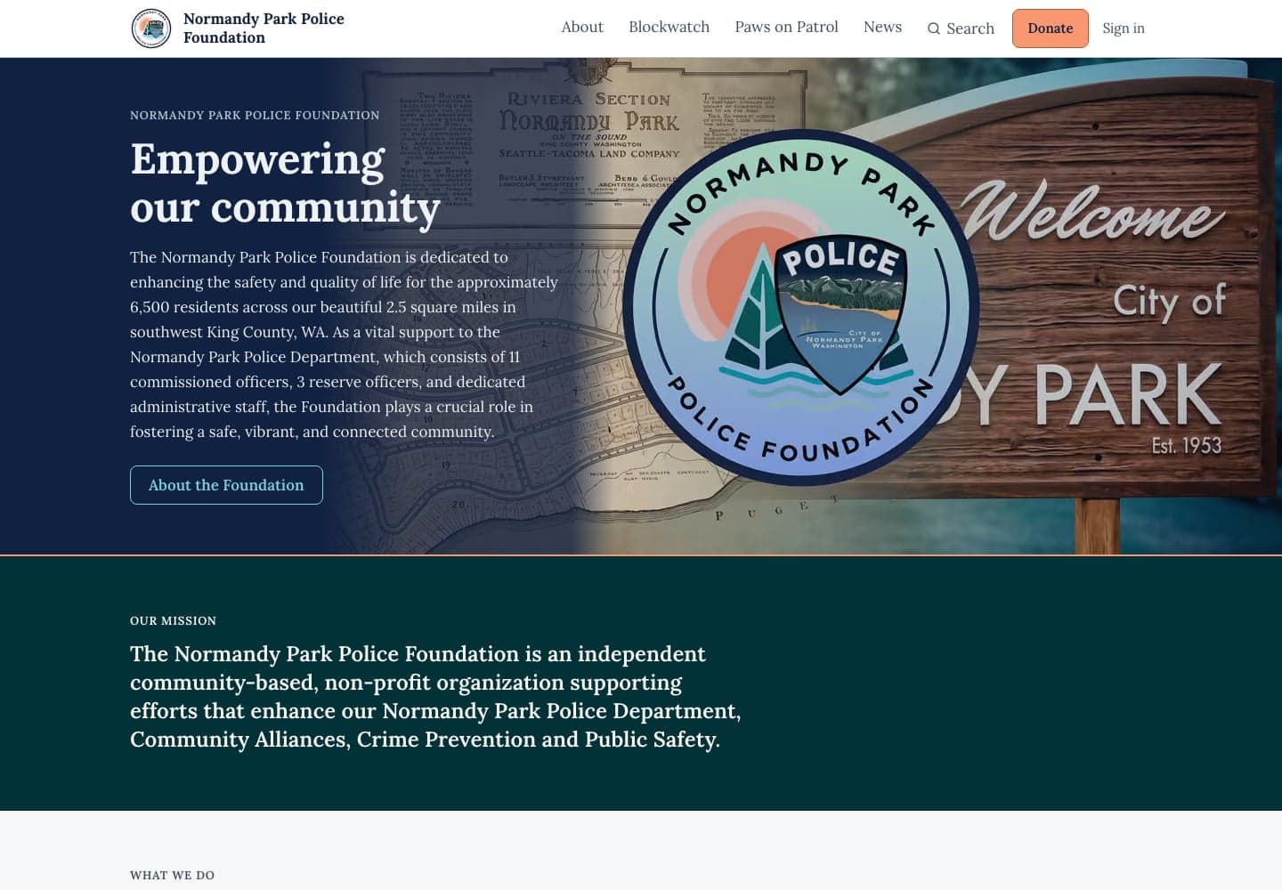 The Foundation's home page: the heading Empowering our community beside the Foundation's seal over a Welcome to the City of Normandy Park sign, with the navigation and an orange Donate button along the top.